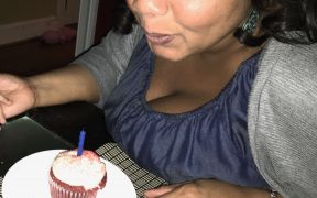 Photo of my sister with a birthday cupcake