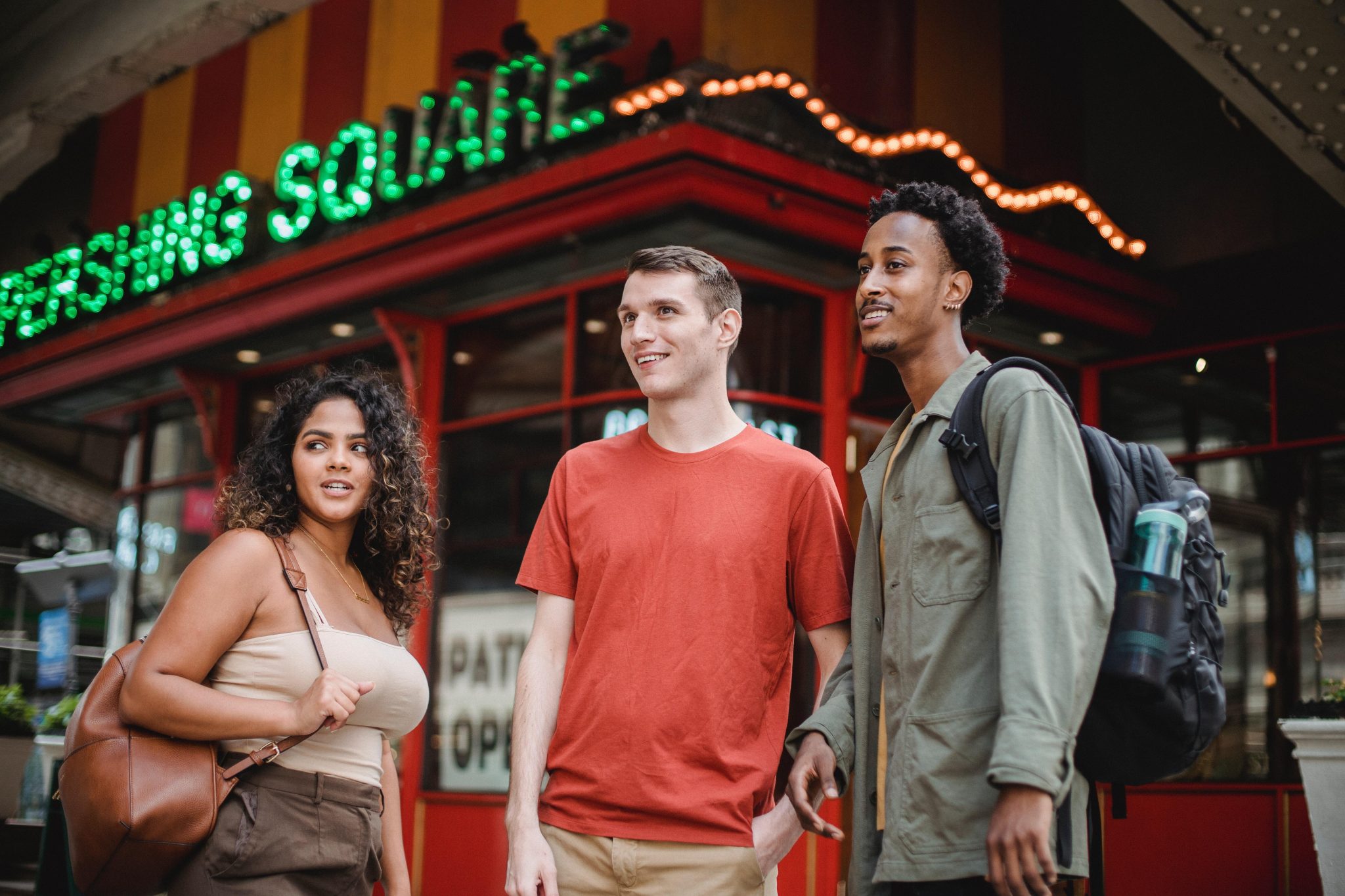A group of people standing in front of a restaurant